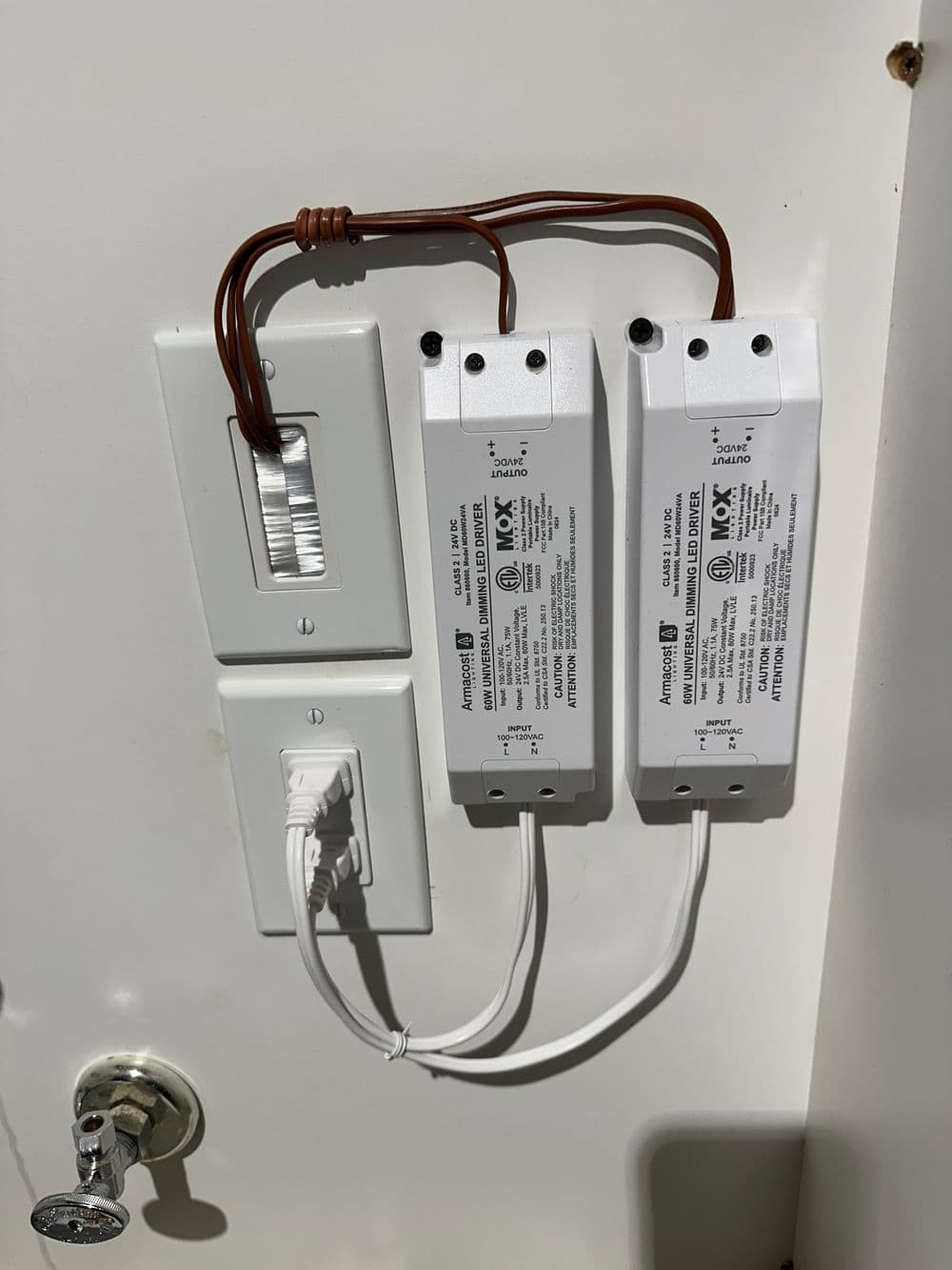 Electrical setup with two drivers and a light switch mounted on a wall.