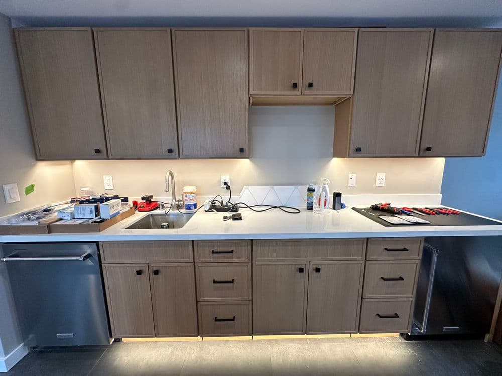 Modern kitchen with wooden cabinets, stainless steel appliances, and a clean countertop.